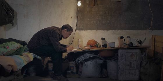 Miner reading at his desk